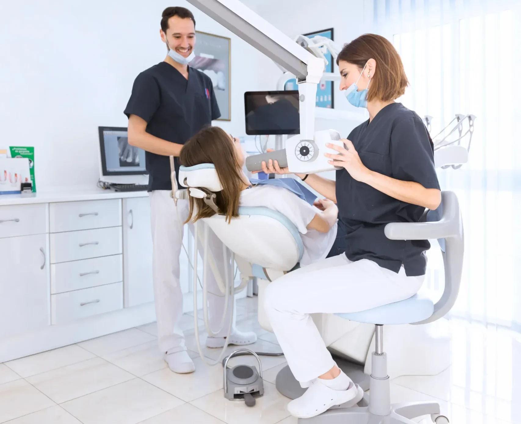 Friendly dental team interacting warmly with a patient at reception or treatment area, calm and supportive environment, natural smiles, clean modern clinic interior, soft daylight, ultra realistic, 8k